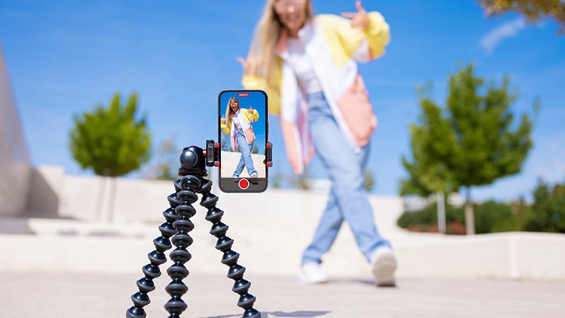 Teenage girl filming video of herself on mobile phone